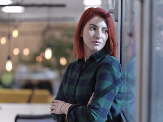 Image showing redhead business woman portrait in creative modern coworking startup open space office