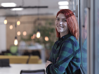 Image showing redhead business woman portrait in creative modern coworking startup open space office