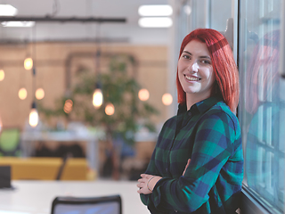 Image showing redhead business woman portrait in creative modern coworking startup open space office