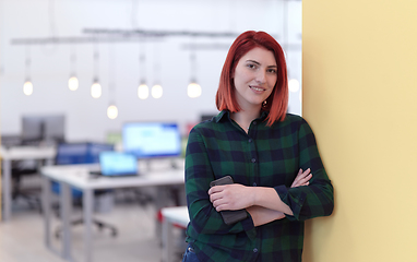 Image showing redhead business woman portrait in creative modern coworking startup open space office