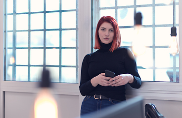 Image showing redhead business woman at office using smart phone