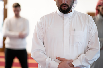 Image showing group of muslim people praying namaz in mosque.