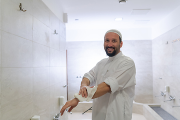 Image showing a portrait of a man in abdesthana using a towel