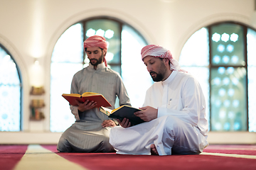 Image showing two muslim people in mosque reading quran together concept of islamic education