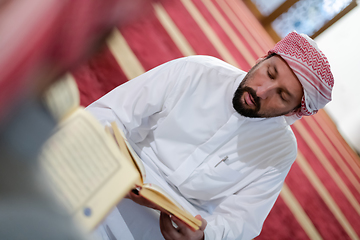 Image showing two muslim people in mosque reading quran together concept of islamic education