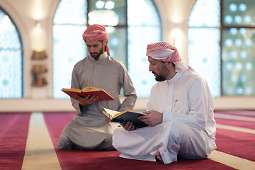 Image showing two muslim people in mosque reading quran together concept of islamic education