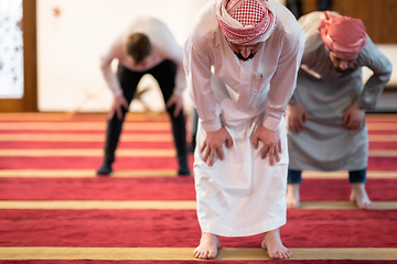 Image showing group of muslim people praying namaz in mosque.