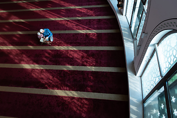 Image showing father and son reading holly book quran together islamic education concept