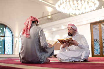 Image showing two muslim people in mosque reading quran together concept of islamic education