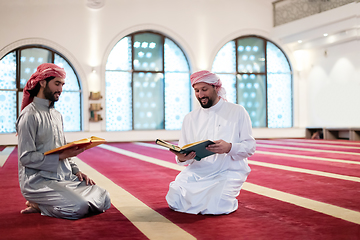 Image showing two muslim people in mosque reading quran together concept of islamic education