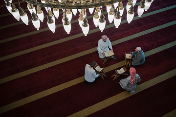 Image showing muslim people in mosque reading quran together