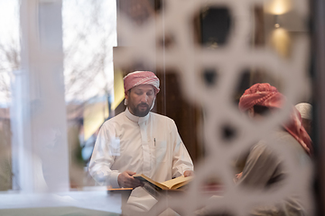 Image showing muslim people in mosque reading quran together