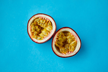 Image showing cut passion fruit on blue background