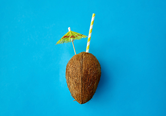 Image showing coconut drink with straw and cocktail umbrella