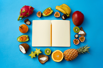 Image showing exotic fruits around notebook with empty pages