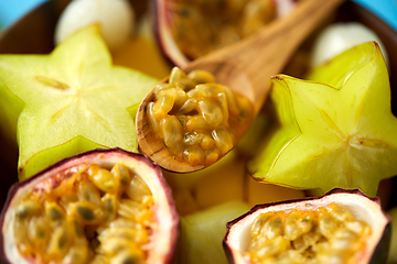 Image showing close up of of exotic fruits mix with wooden spoon