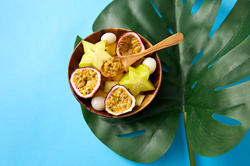 Image showing mix of exotic fruits in wooden plate with spoon