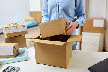 Image showing woman packing parcel boxes at post office