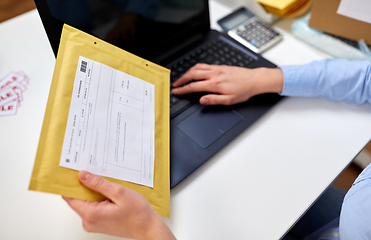 Image showing hands with laptop and envelope at post office