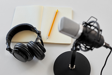 Image showing headphones, microphone and notebook with pencil