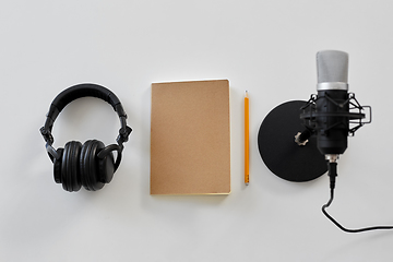 Image showing headphones, microphone and notebook with pencil