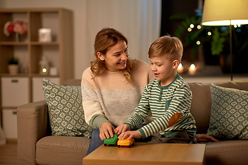 Image showing mother and son playing with toy cars at home