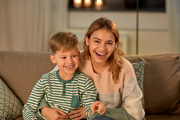 Image showing happy laughing mother with her son at home