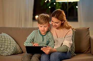 Image showing mother and son using tablet computer at home