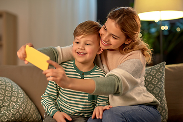 Image showing mother and son taking selfie by smartphone at home