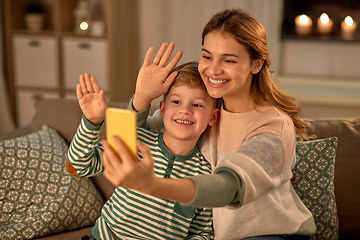 Image showing mother and son taking selfie by smartphone at home