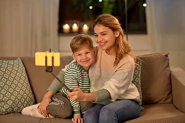 Image showing mother and son taking selfie by smartphone at home