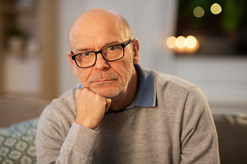 Image showing sad senior man in glasses thinking at home