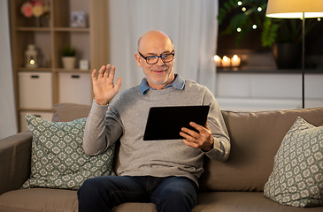 Image showing old man with tablet pc having video call at home