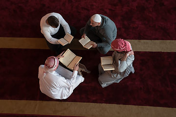 Image showing muslim people in mosque reading quran together