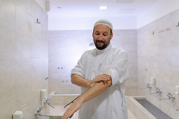 Image showing a portrait of a man in abdesthana using a towel