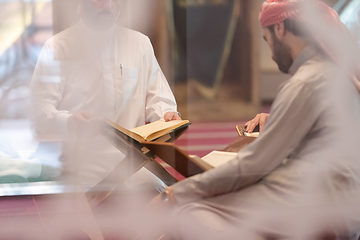 Image showing muslim people in mosque reading quran together