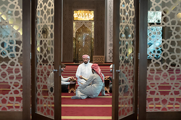 Image showing muslim people in mosque reading quran together