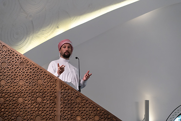 Image showing Muslims young arabic Imam has a speech on friday afternoon prayer in mosque.