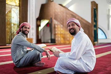 Image showing two muslim people in mosque reading quran together concept of islamic education