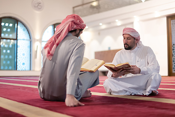 Image showing two muslim people in mosque reading quran together concept of islamic education