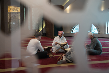 Image showing muslim people in mosque reading quran together