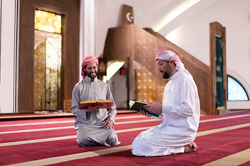 Image showing two muslim people in mosque reading quran together concept of islamic education