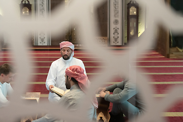 Image showing muslim people in mosque reading quran together