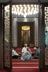 Image showing muslim people in mosque reading quran together