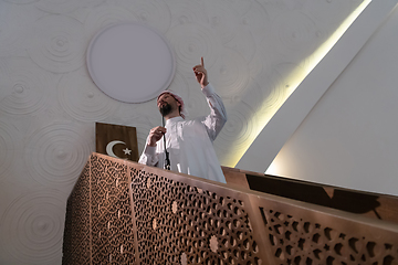 Image showing Muslims young arabic Imam has a speech on friday afternoon prayer in mosque.