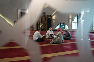 Image showing muslim people in mosque reading quran together