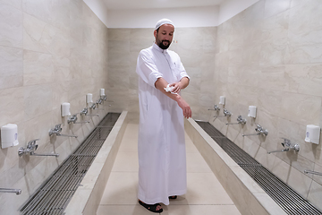 Image showing a portrait of a man in abdesthana using a towel