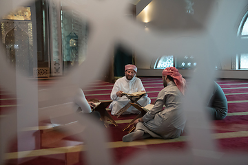 Image showing muslim people in mosque reading quran together