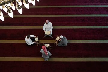 Image showing muslim people in mosque reading quran together