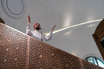 Image showing Muslims young arabic Imam has a speech on friday afternoon prayer in mosque.